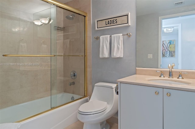 full bathroom with vanity, combined bath / shower with glass door, and toilet