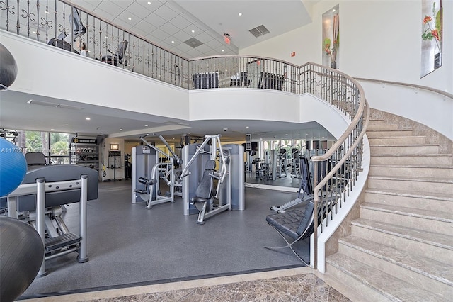 exercise room with a towering ceiling