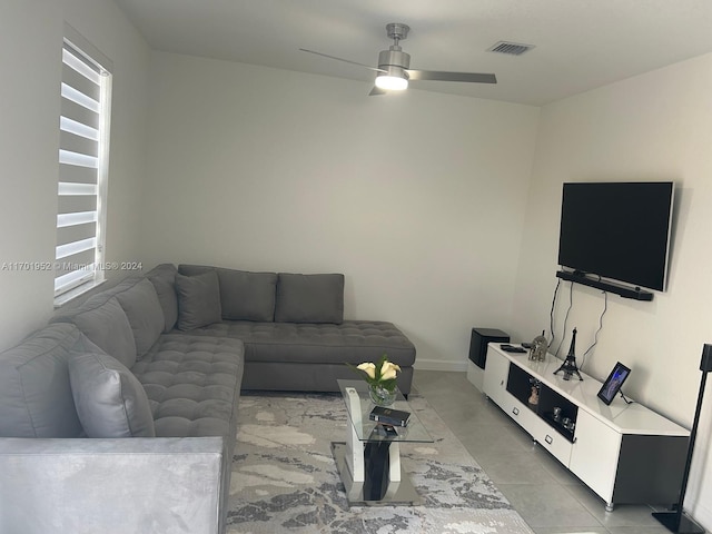 tiled living room featuring ceiling fan