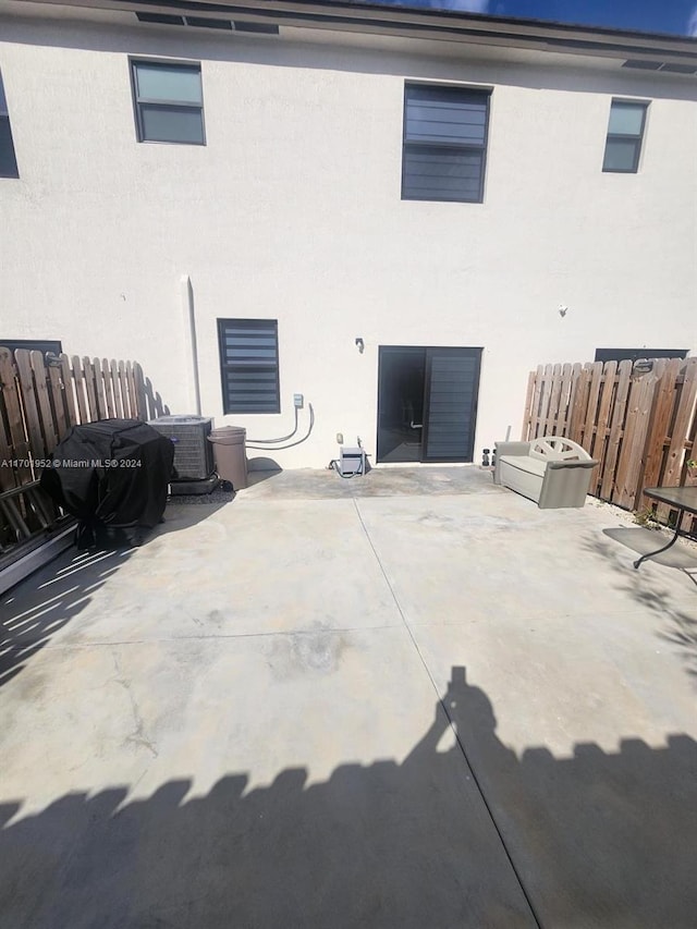 back of house featuring central air condition unit and a patio