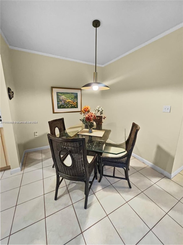 dining space featuring light tile patterned floors and crown molding