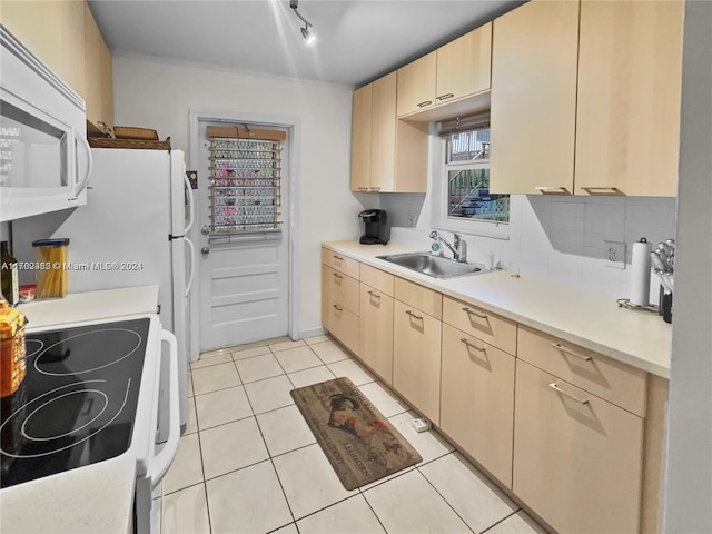 kitchen featuring light brown cabinetry, white appliances, light tile patterned floors, and sink