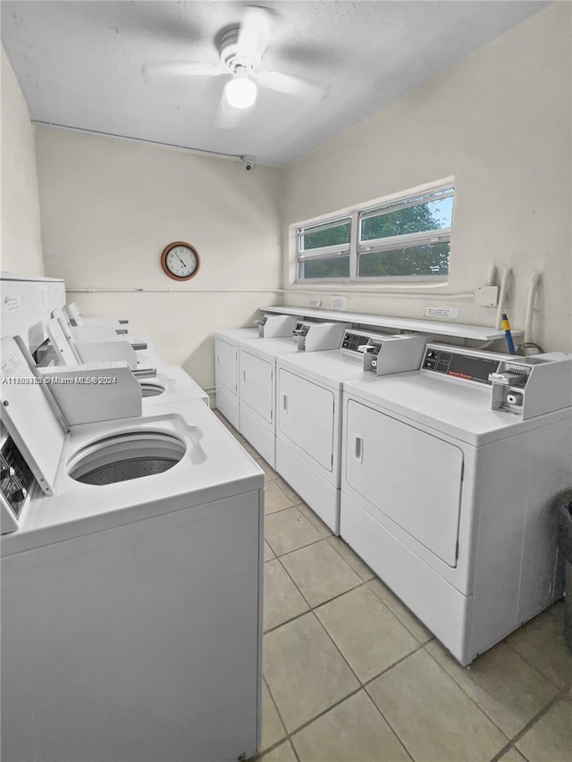 clothes washing area featuring light tile patterned floors, separate washer and dryer, and ceiling fan