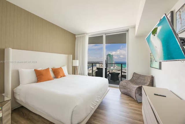 bedroom featuring light hardwood / wood-style floors and access to exterior