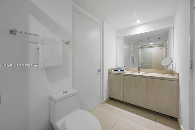 bathroom with tile patterned flooring, vanity, and toilet