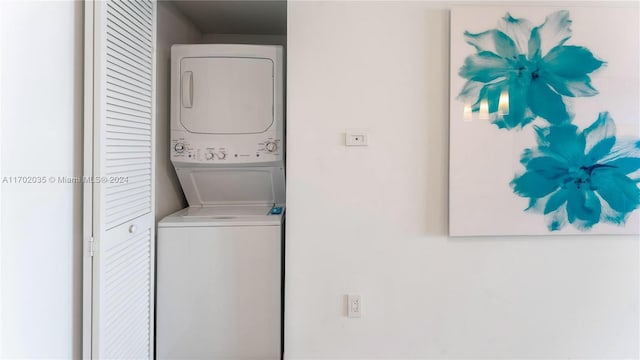 laundry room with stacked washing maching and dryer