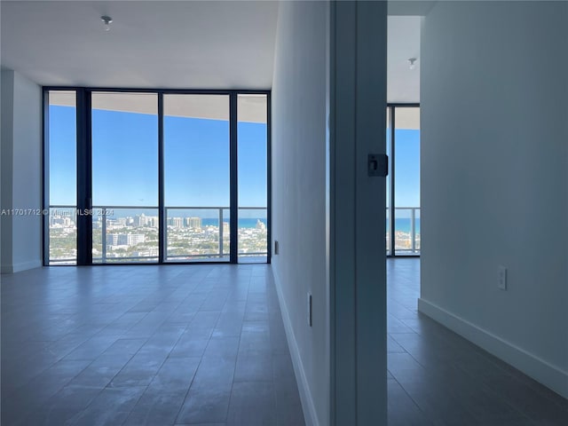 empty room featuring a wall of windows