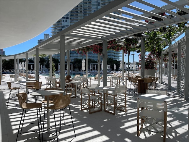 view of patio / terrace with a pergola and a community pool