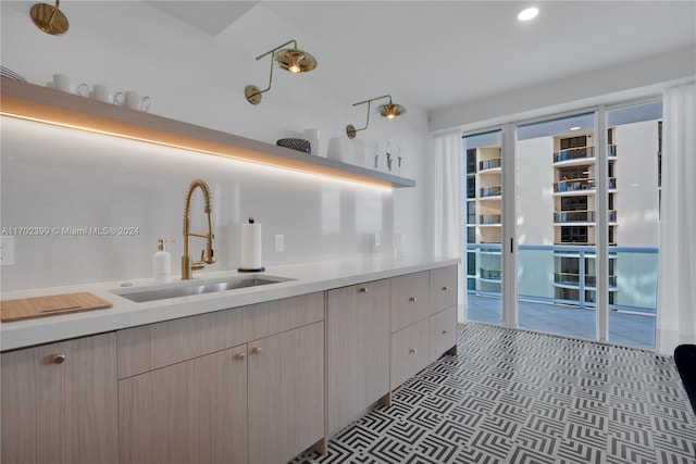 kitchen with light brown cabinets and sink