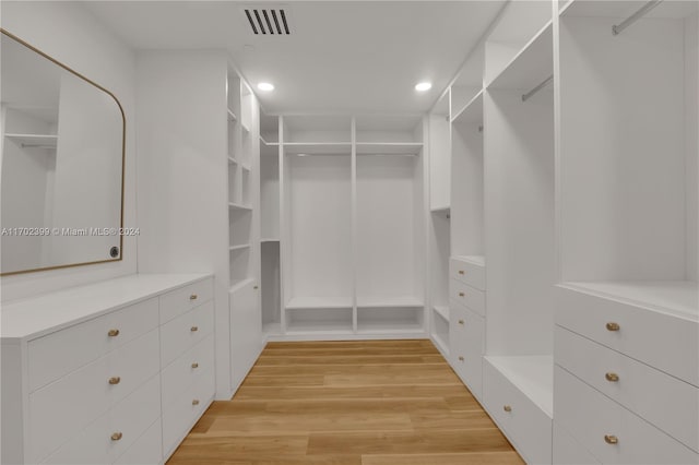 walk in closet with light wood-type flooring