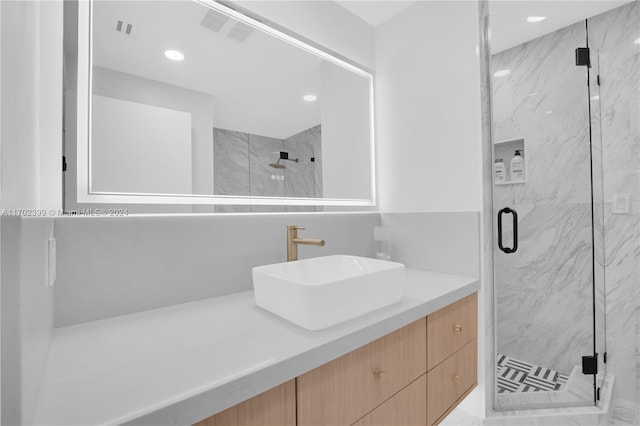 bathroom with vanity and an enclosed shower