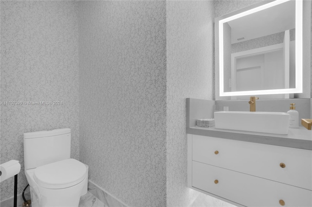 bathroom featuring vanity and toilet