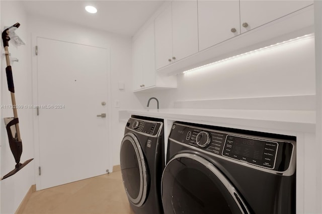 laundry room with cabinets and washer and clothes dryer