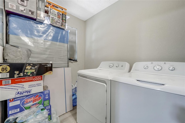 laundry area featuring light hardwood / wood-style flooring and washing machine and clothes dryer