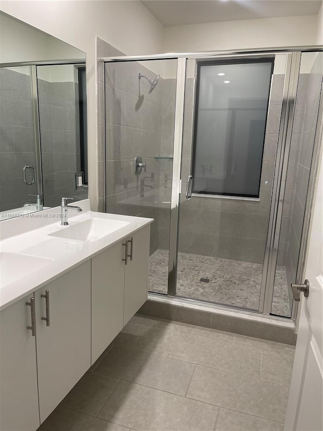 bathroom featuring tile patterned flooring, vanity, and an enclosed shower