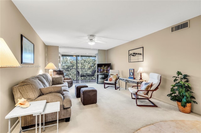 carpeted living room featuring ceiling fan