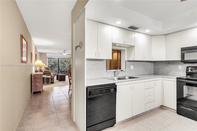 kitchen featuring backsplash, black appliances, white cabinets, sink, and light tile patterned flooring