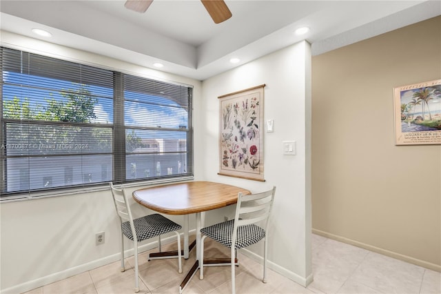 tiled dining space featuring ceiling fan