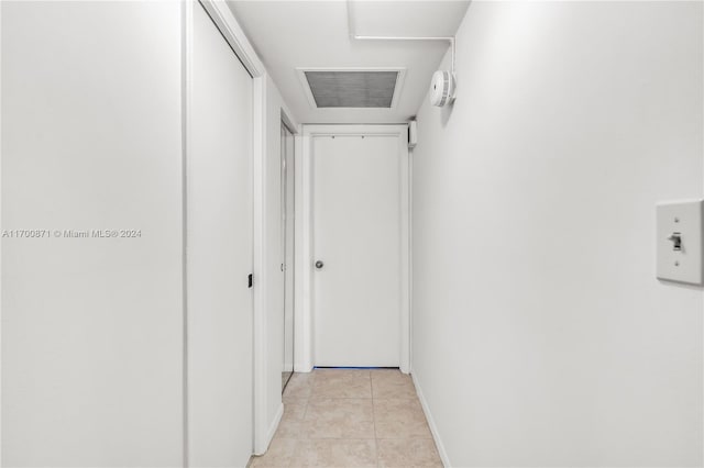 hall featuring light tile patterned floors