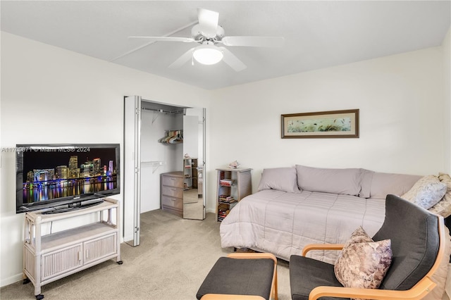 bedroom with a closet, light colored carpet, and ceiling fan