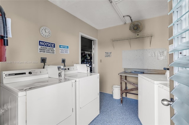 washroom featuring washer and dryer and a textured ceiling