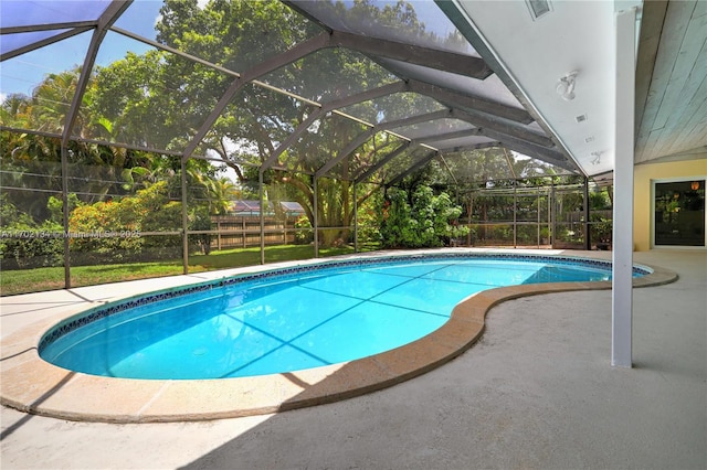 view of swimming pool with a patio and glass enclosure