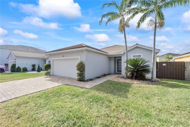 single story home with a front yard and a garage