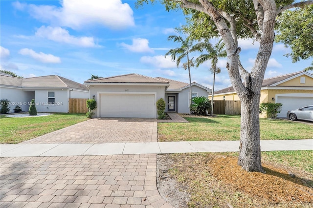 ranch-style house with a front lawn and a garage