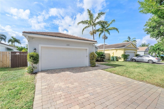 view of front of home with a garage and a front yard