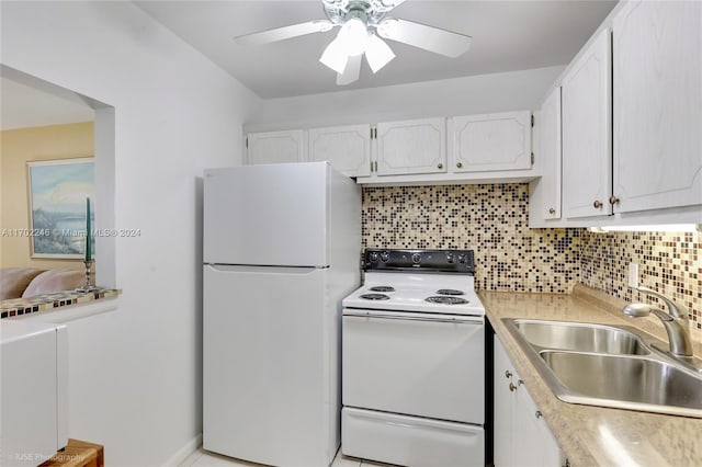 kitchen with tasteful backsplash, white appliances, ceiling fan, sink, and white cabinetry