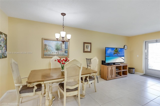 dining area with light tile patterned floors and a chandelier