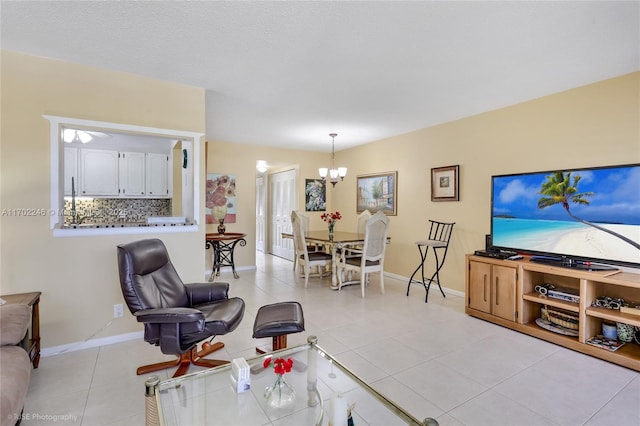 living room featuring a notable chandelier and light tile patterned floors