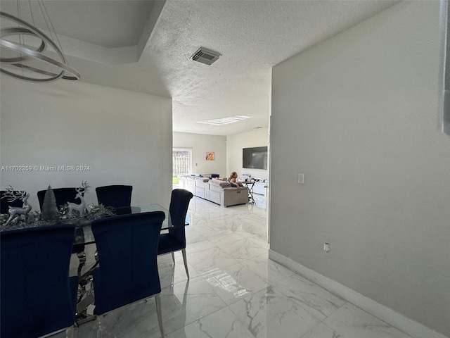 dining area featuring a textured ceiling