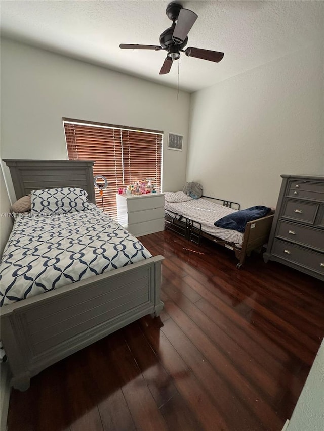 bedroom featuring ceiling fan and dark wood-type flooring