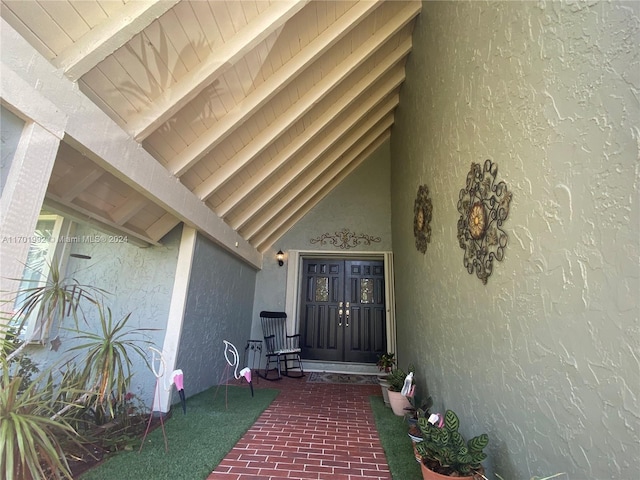 doorway to property featuring covered porch