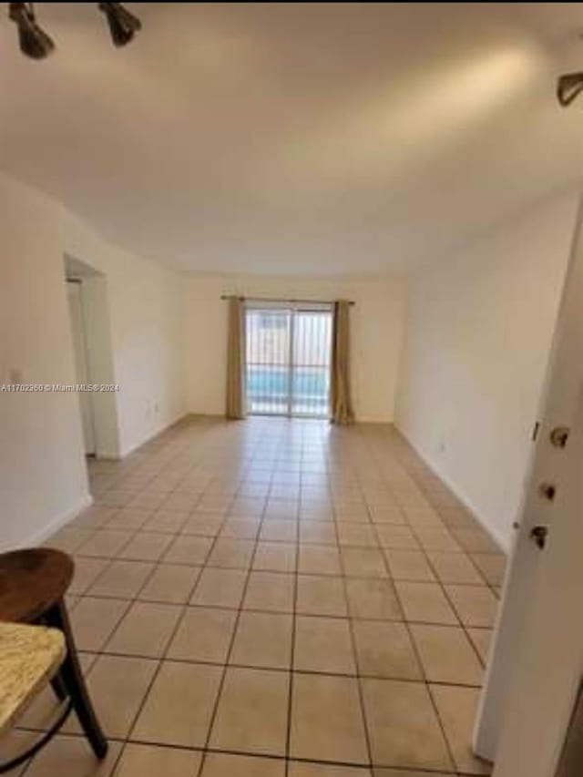 spare room featuring light tile patterned floors