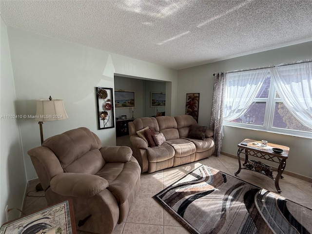 living room with light tile patterned flooring and a textured ceiling