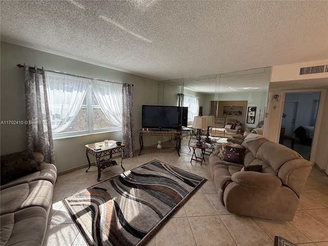 tiled living room featuring a textured ceiling