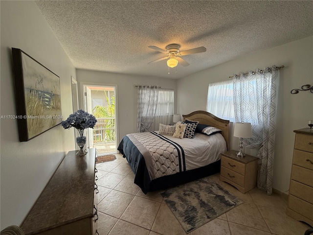 bedroom with ceiling fan, a textured ceiling, access to outside, and multiple windows