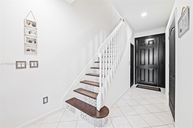 stairway with tile patterned flooring