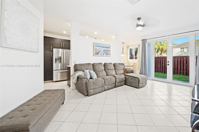 living room featuring light tile patterned floors and ceiling fan