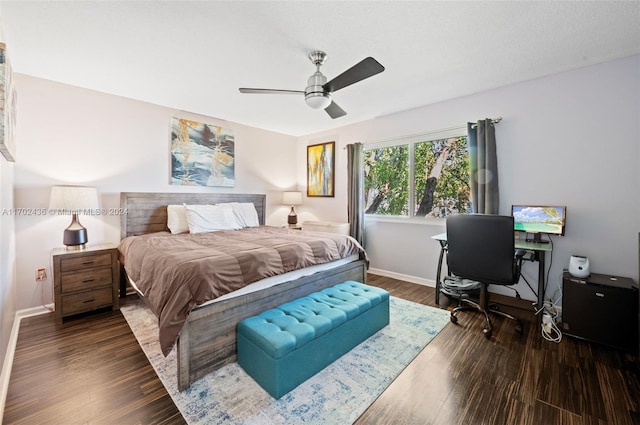 bedroom with ceiling fan and dark wood-type flooring