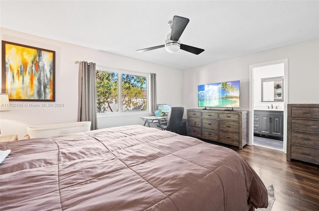 bedroom with ensuite bath, ceiling fan, sink, and dark hardwood / wood-style floors