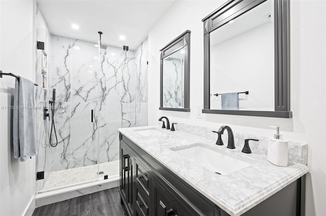 bathroom featuring hardwood / wood-style floors, vanity, and a shower with door