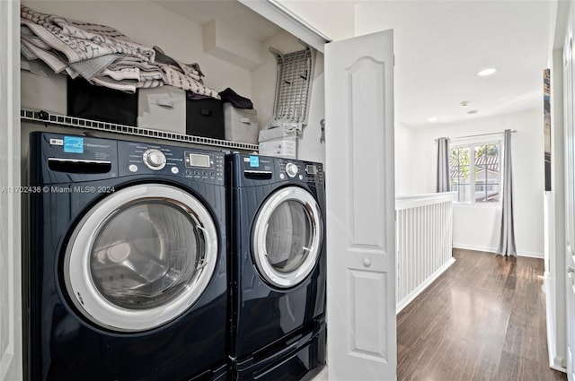 clothes washing area featuring washing machine and clothes dryer and wood-type flooring