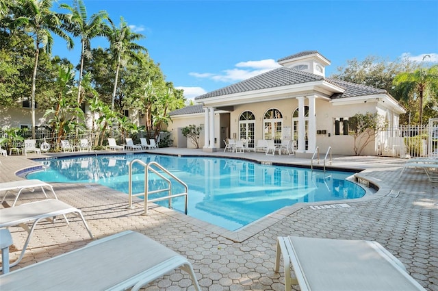 view of swimming pool featuring a patio and french doors