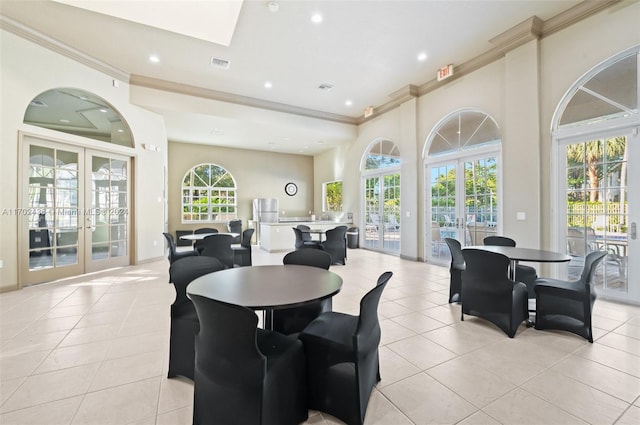 dining room with crown molding, french doors, and light tile patterned flooring