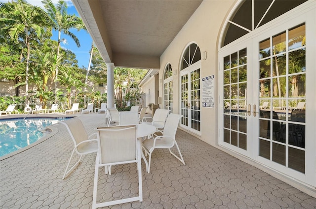 view of patio / terrace with a community pool and french doors