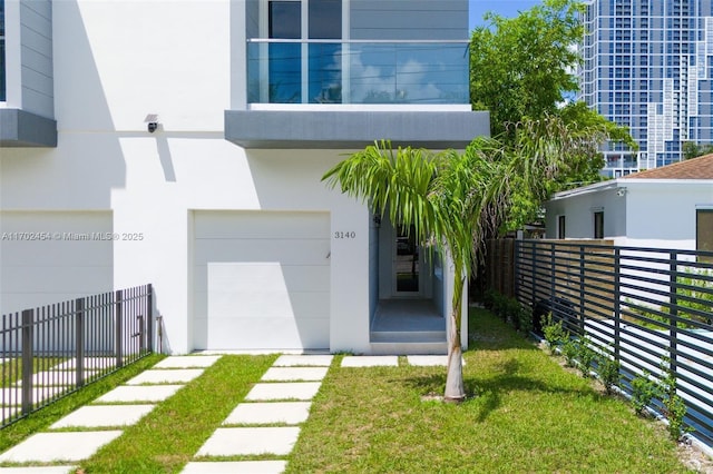 view of front of property with a garage and a front lawn