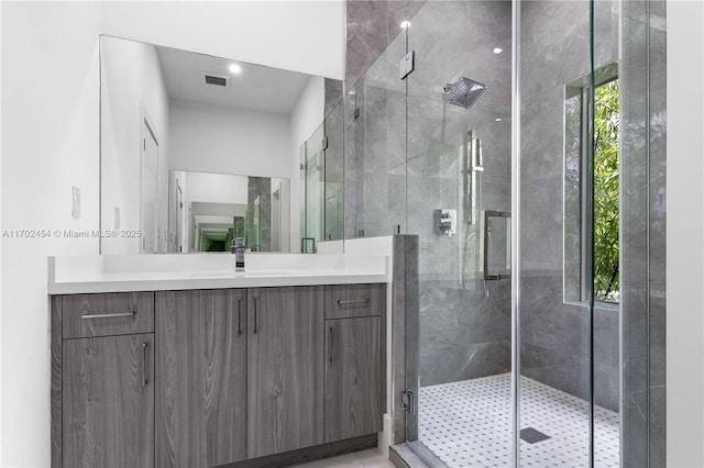 bathroom featuring vanity and a shower with shower door